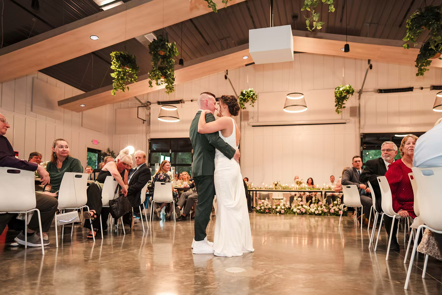 A panoramic view of a couple dancing in reception hall at Retreat 21 Wedding Venue