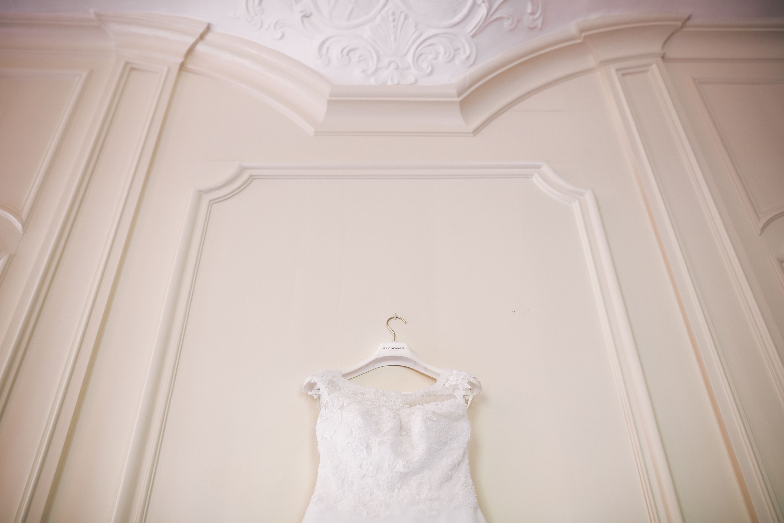 Elegant white crown molding and ornate architectural details adorn the walls and ceiling of a luxurious room.