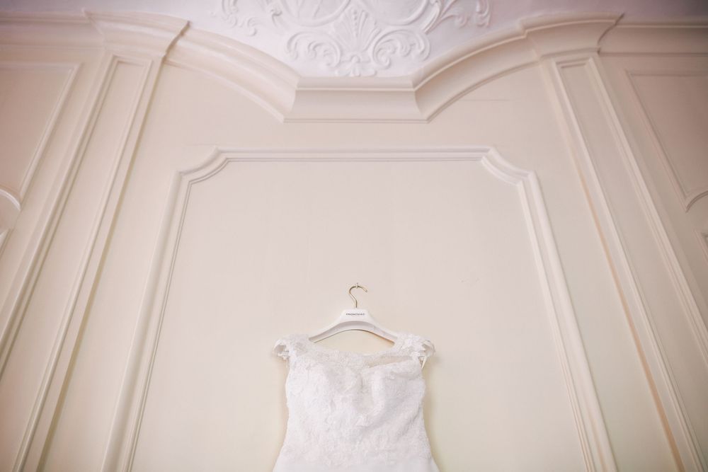 Elegant white crown molding and ornate architectural details adorn the walls and ceiling of a luxurious room.