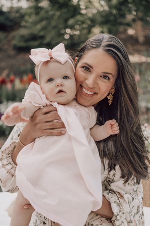 A collection of sweet moments captured in warm tones with floral dresses and pink bows.