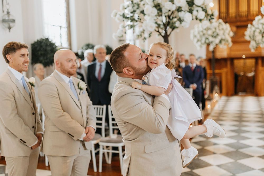 A collage of four wedding photos showing tender moments between family members in a church setting with beige attire.