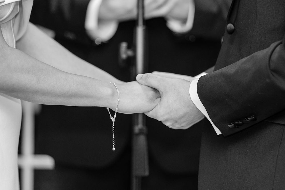 Bride and groom holding hands during wedding ceremony at The Saphire Estate