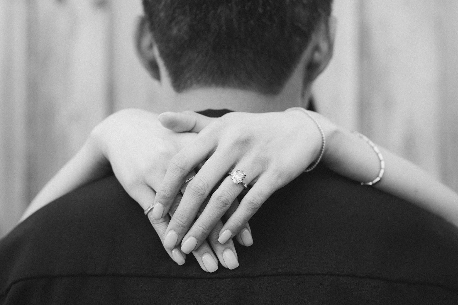 A tender black and white photograph shows a parent sharing an intimate bonding moment with a small baby.