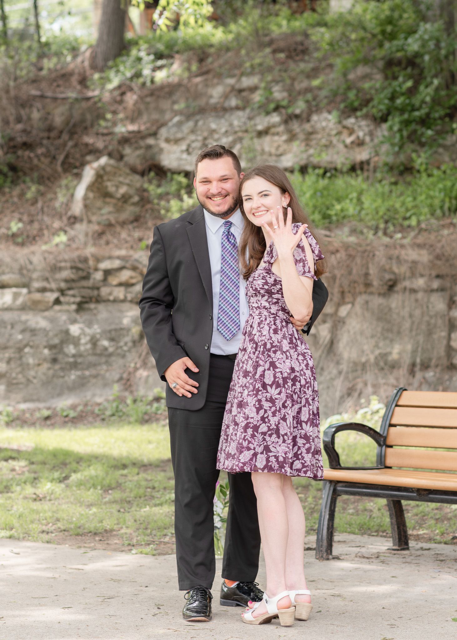 Happy engaged couple smiling together during engagement photos at Nolan Creek Trail in Temple Texas