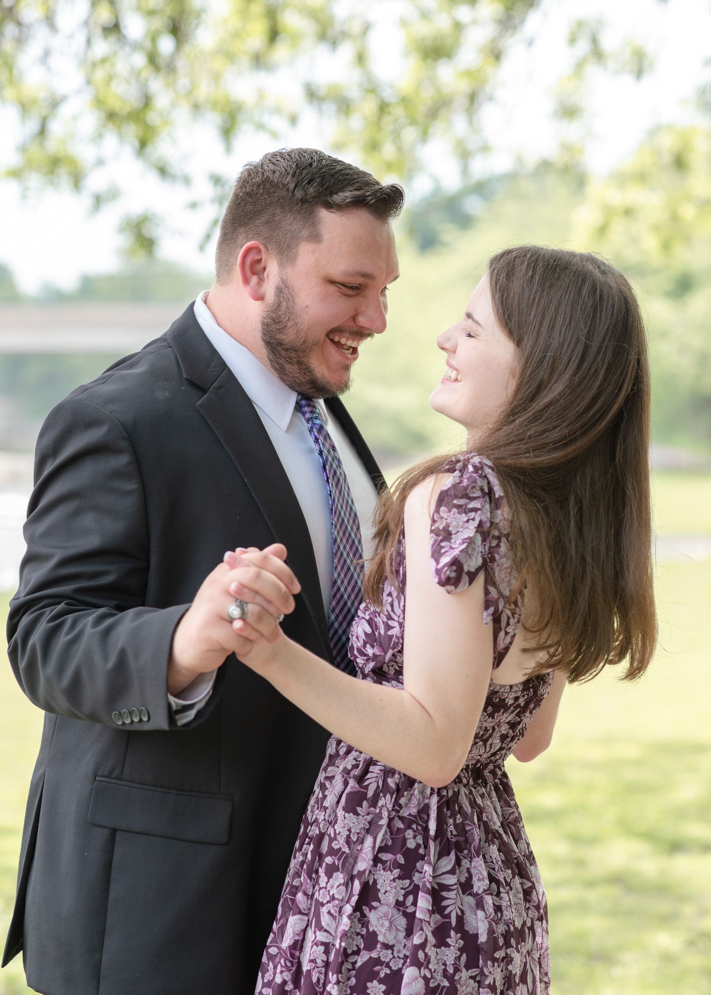 Couple sharing a quiet moment during golden hour engagement photos in Temple Texas at Nolan Creek Trail