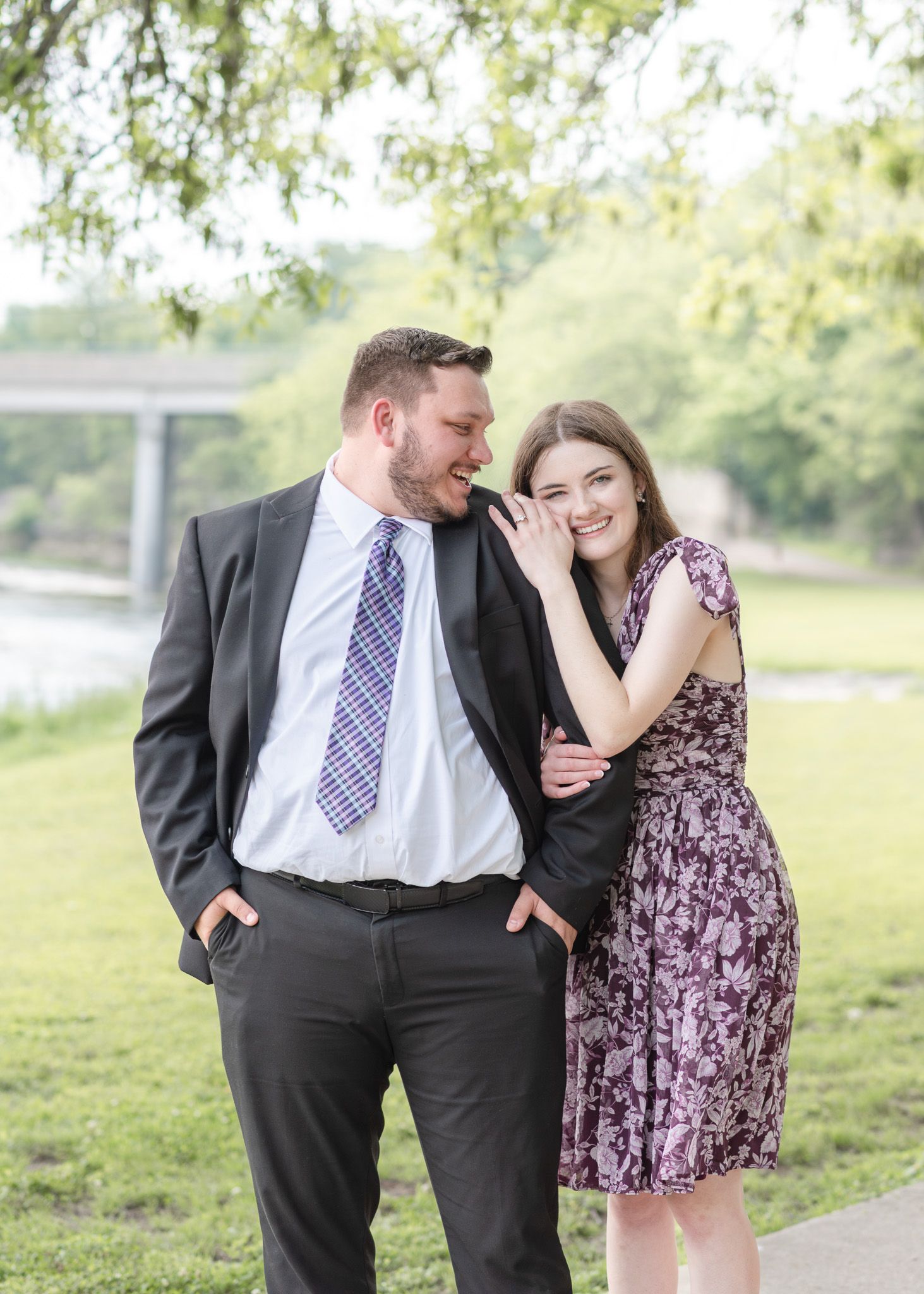 Engaged couple walking together at Nolan Creek Trail in Temple Texas during relaxed outdoor engagement session
