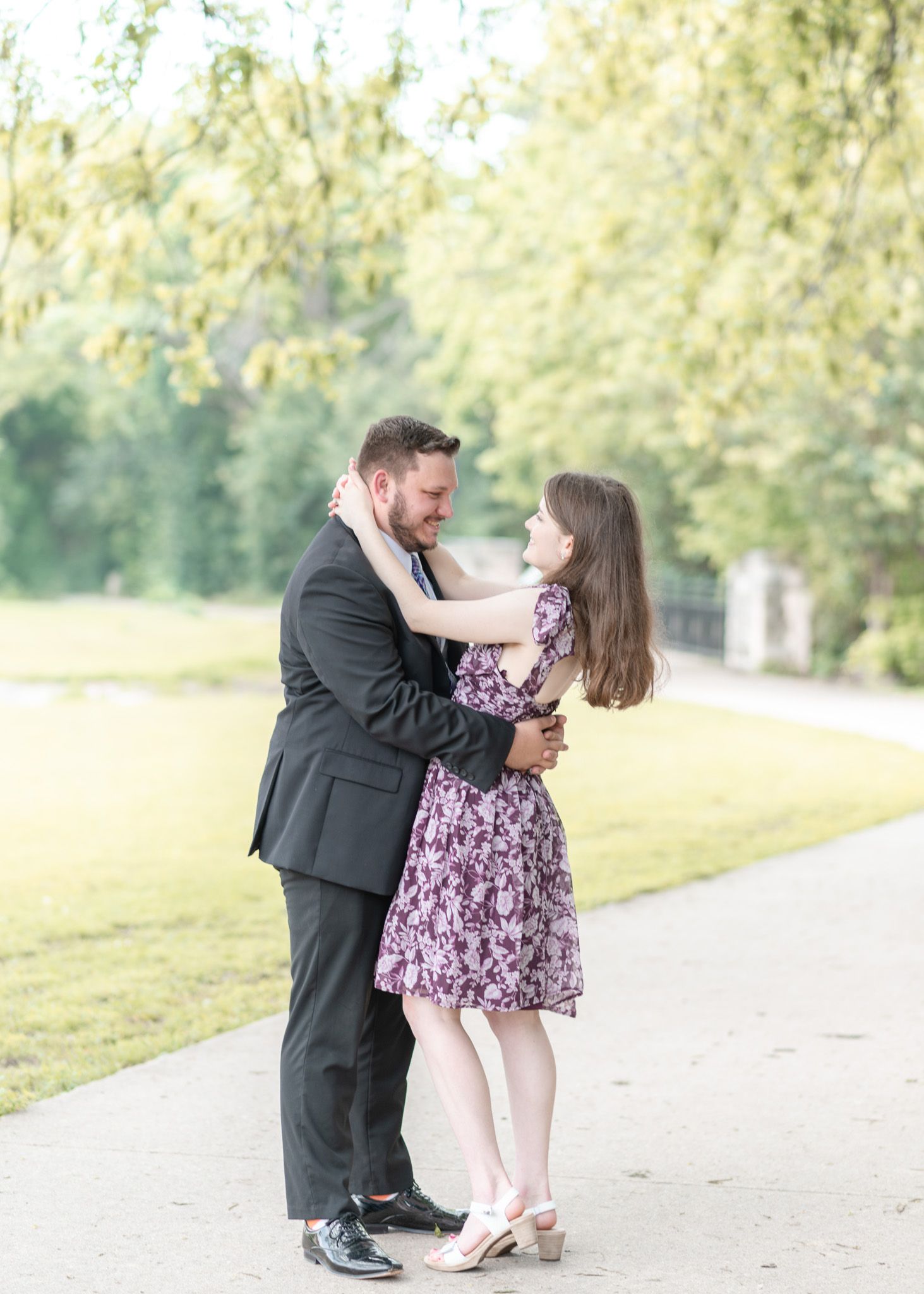 Engaged couple standing together on a tree lined path at Nolan Creek Trail in Temple Texas during outdoor session