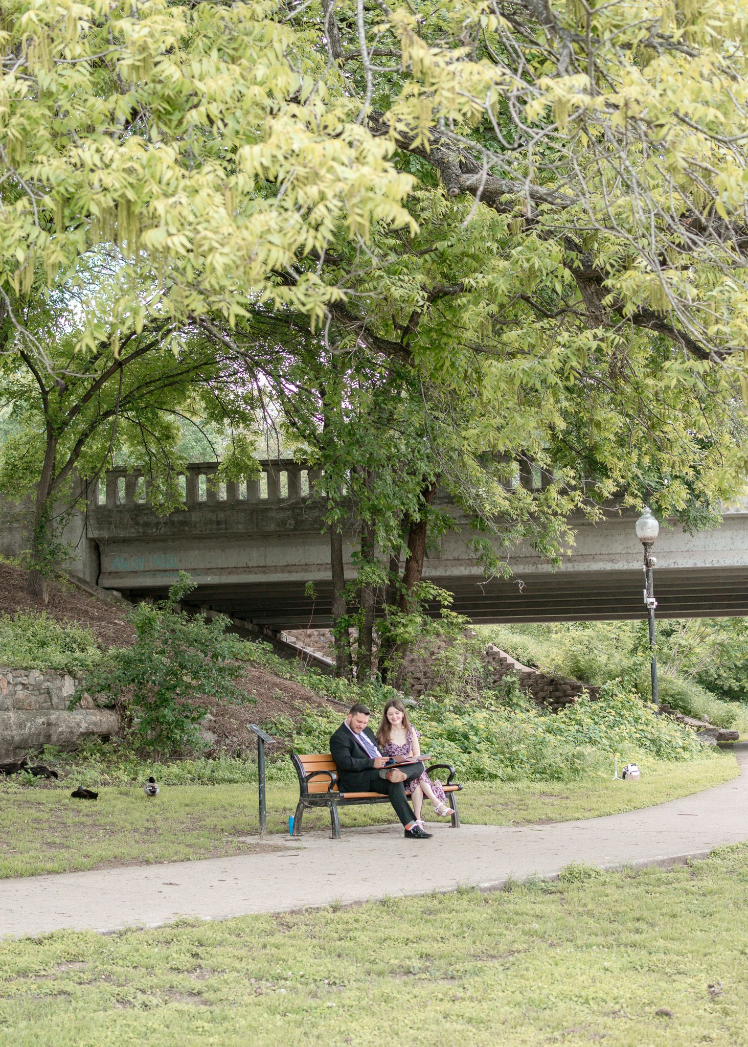 Scenic view of Nolan Creek Trail in Temple Texas with trees, walking path, and bridge during family photo session