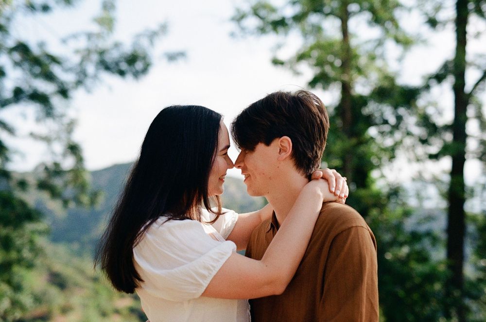 Iconic Griffith Observatory architecture in the background of a candid, documentary engagement session for an NC-based photographer.