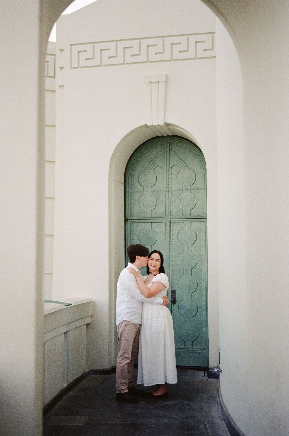 Chill, documentary-style engagement session at Griffith Observatory, featuring 10 years of hybrid film experience for North Carolina couples