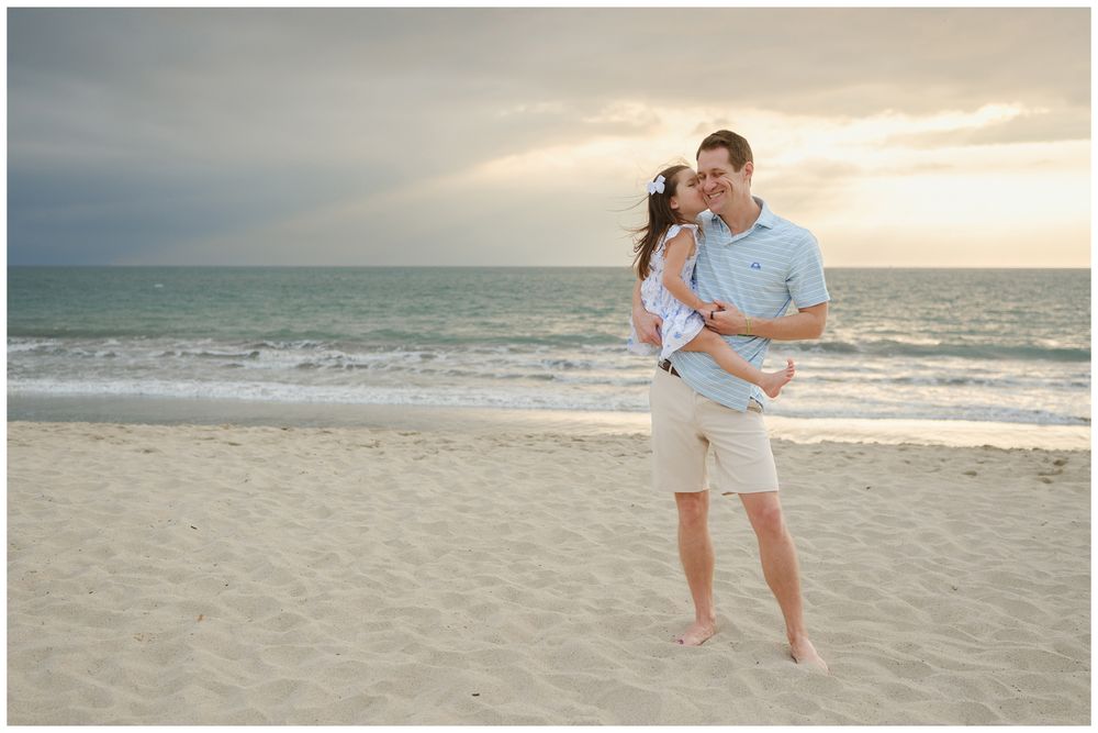 Beach family photos at Villa del Palmar Flamingos of a father embracing his daughter on the beach at sunset.