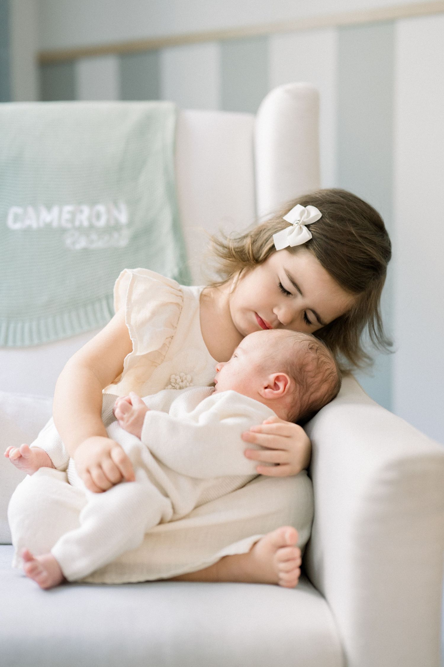 big sister and newborn hug at a newborn session in a home in washington dc