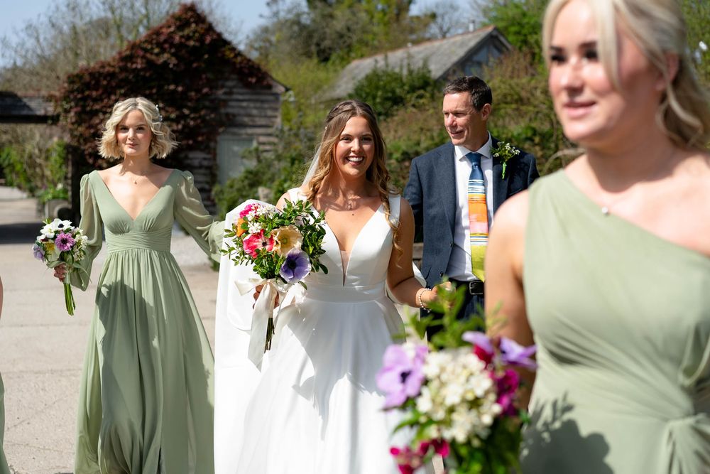 Bride and Wedding party walking to the ceremony at Nancarrow Farm