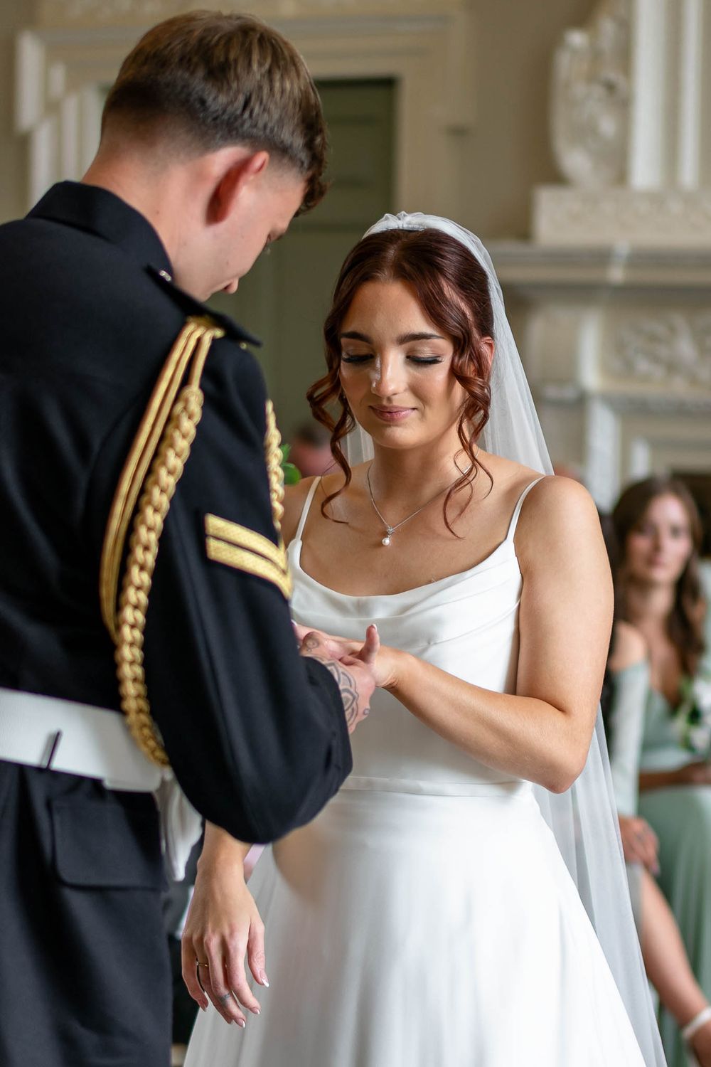 Bride and Groom exchanging rings during ceremony at Crowcombe Court