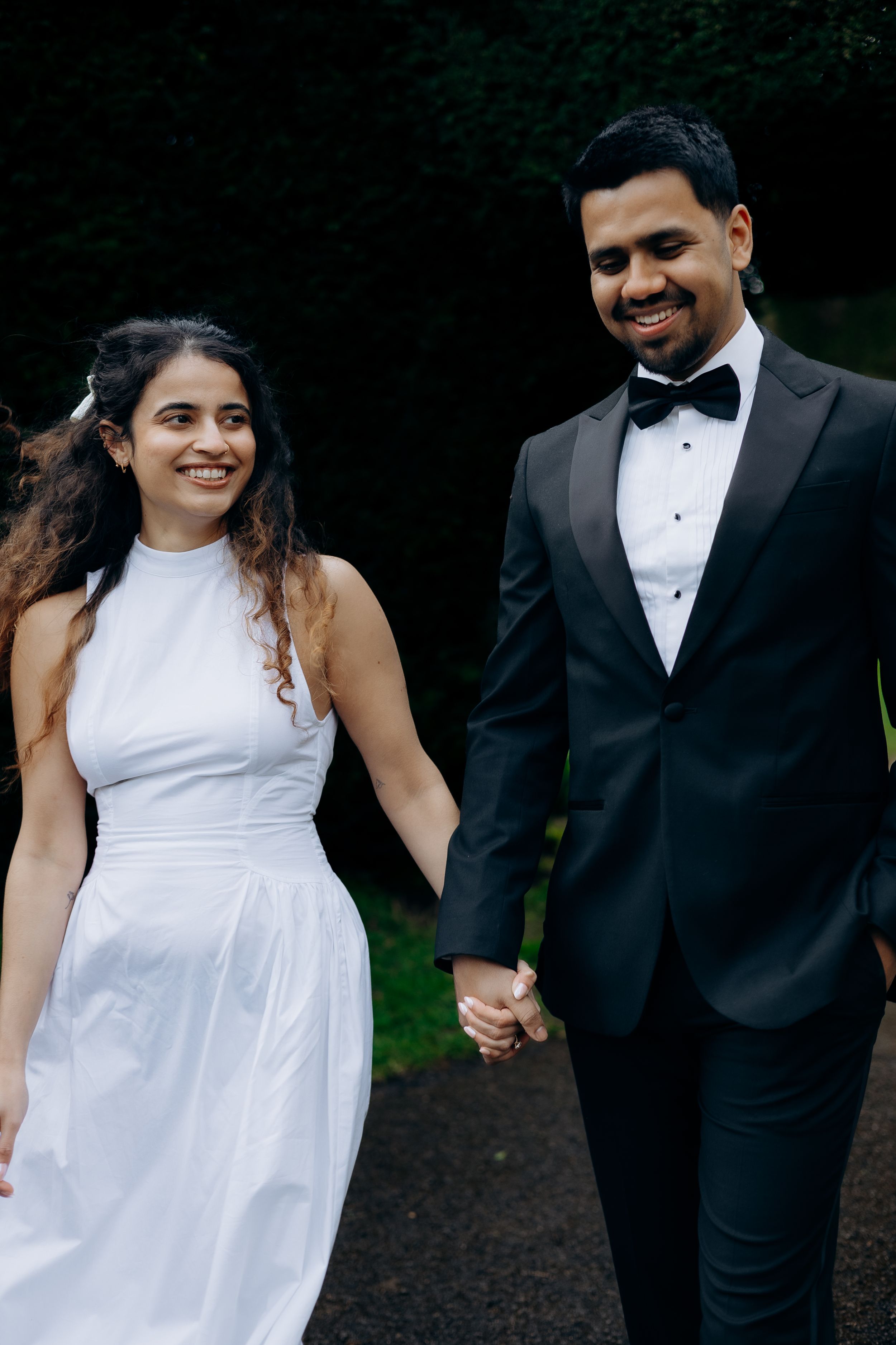 Bride and groom having their photos taken in Painswick captured by a Cotswolds wedding photographer.