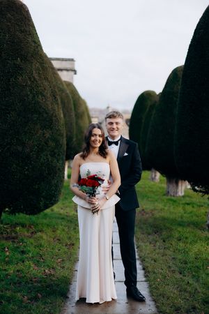 Bride and groom having their photos taken in Painswick captured by a Cotswolds wedding photographer.