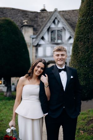 Bride and groom having their photos taken in Painswick captured by a Cotswolds wedding photographer.