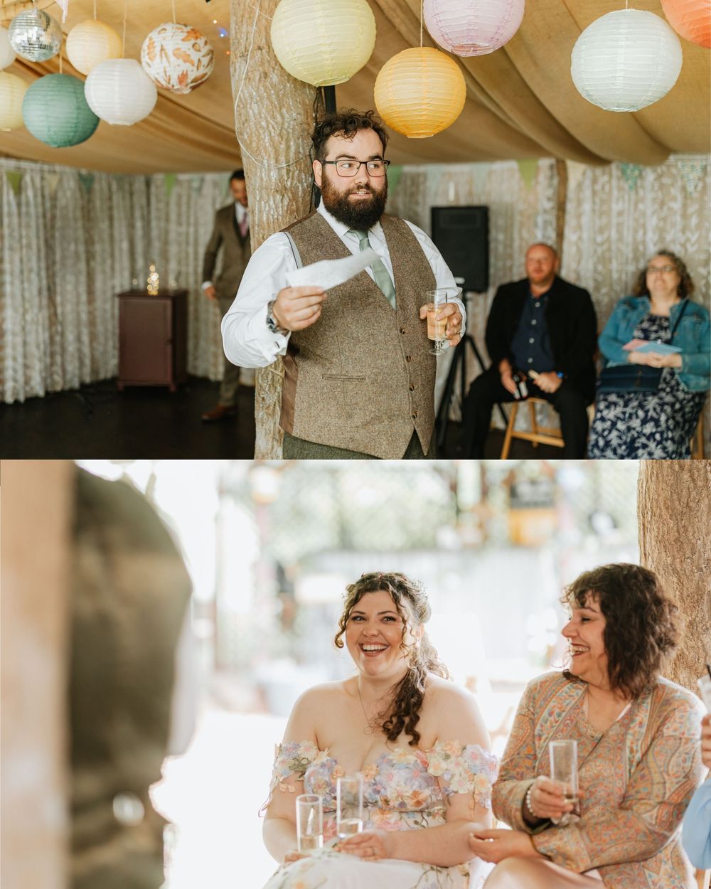 Bearded groom in tweed vest reads wedding speech under colorful paper lanterns while bride and guests laugh joyfully.