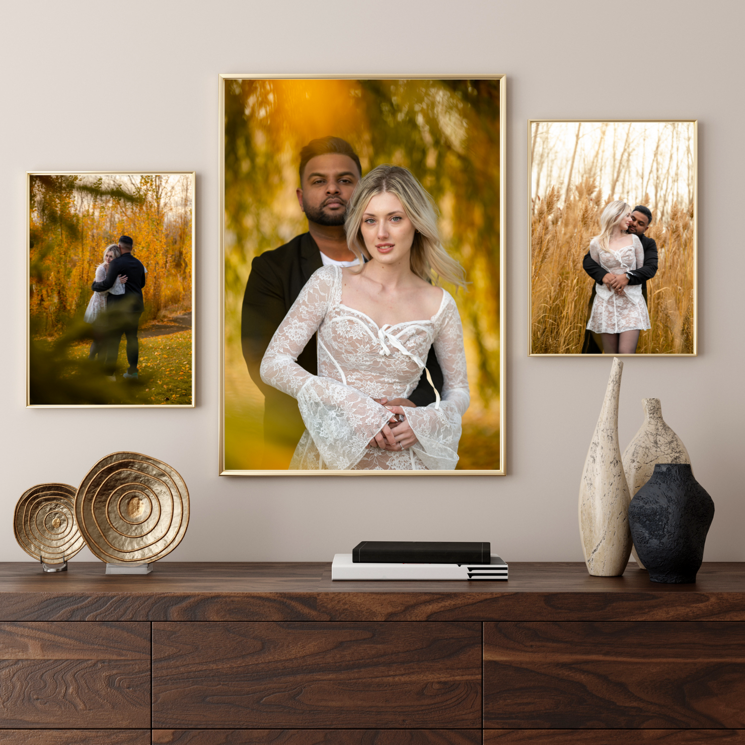 Romantic framed wedding photos displayed on a wooden sideboard with decorative vases and metal plates as decor.