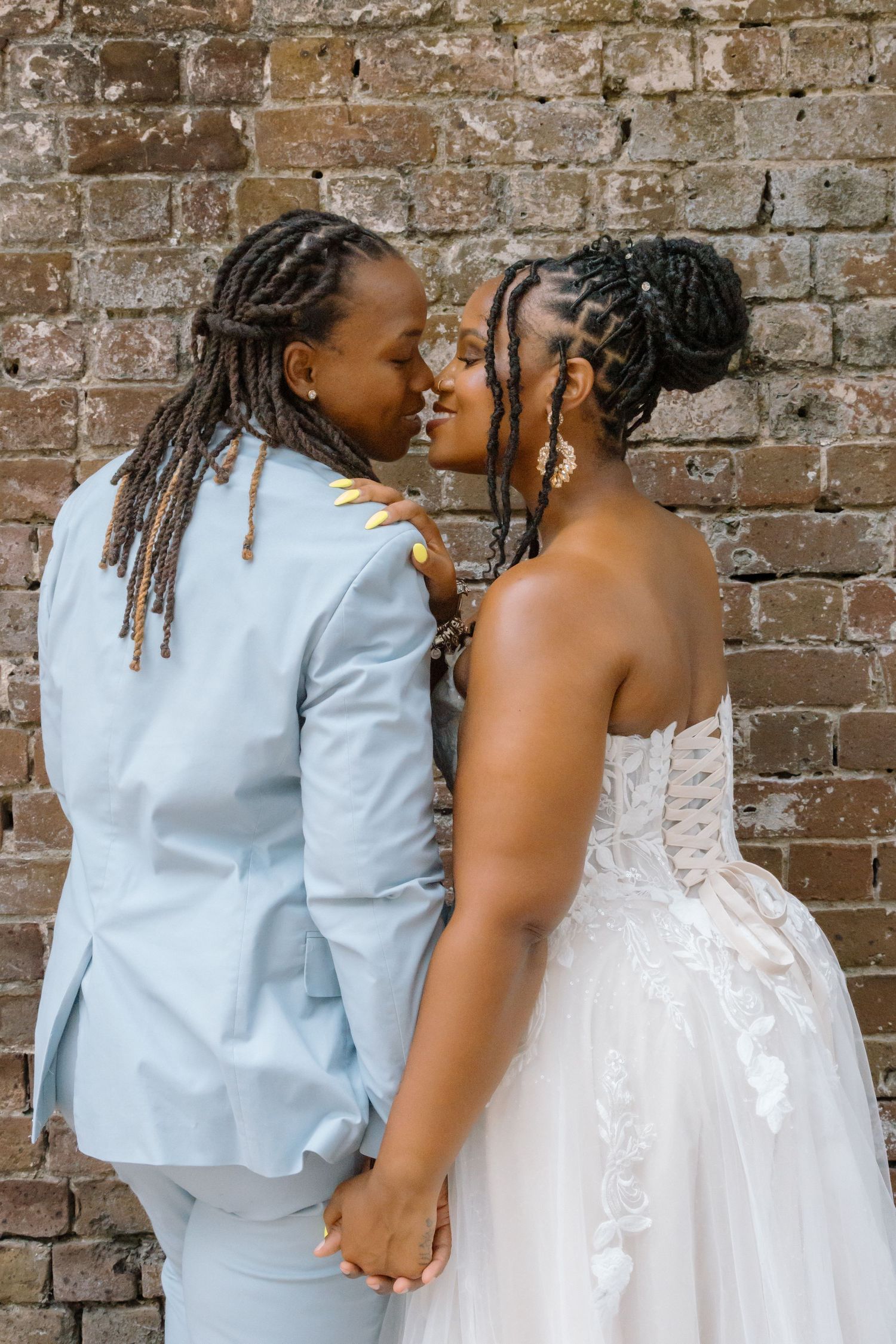 LGBTQ couple holding hands after romantic courthouse elopement at blue ridge mountain overlook near Asheville, North Carolina