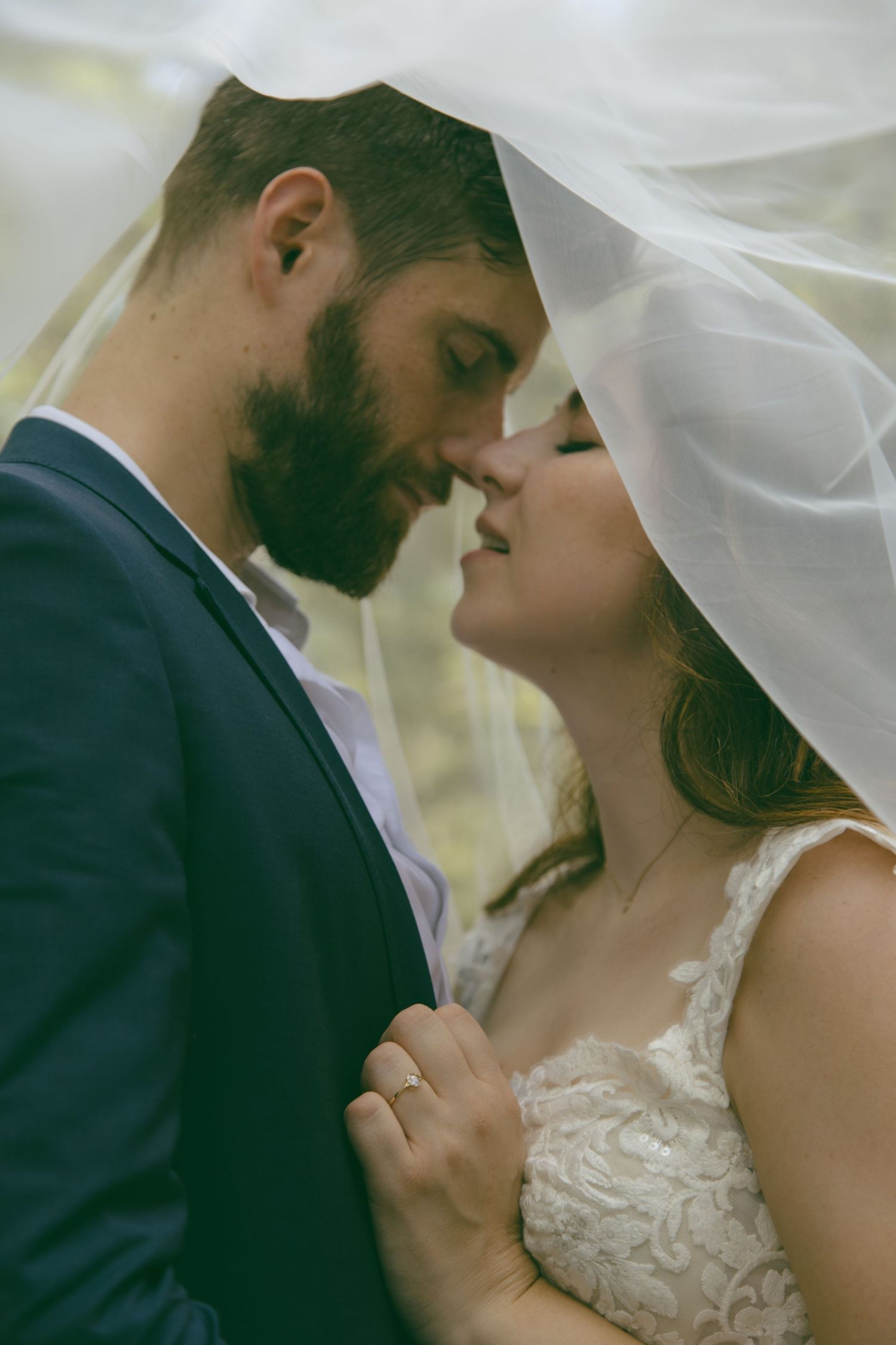 bride and groom under veil romantic kiss wedding elopement