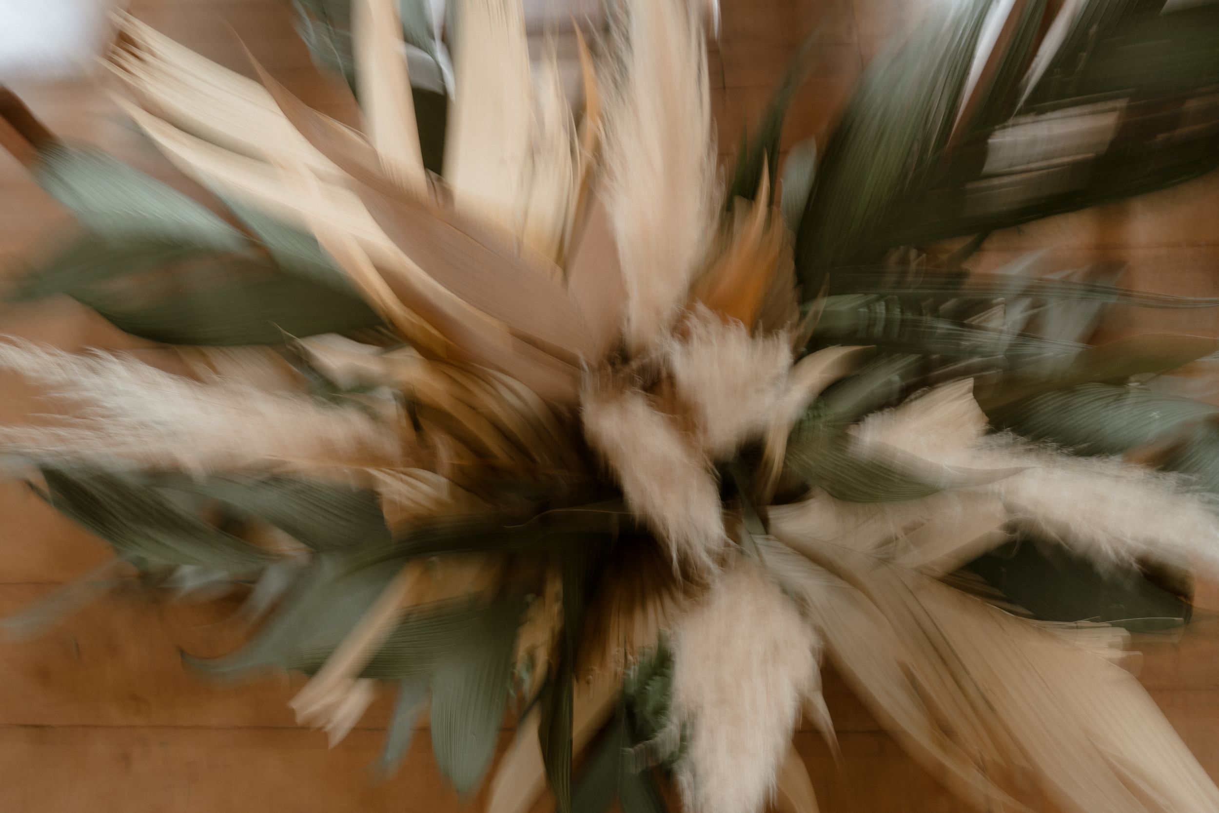 Abstract motion blur of dried floral wedding arrangements.
