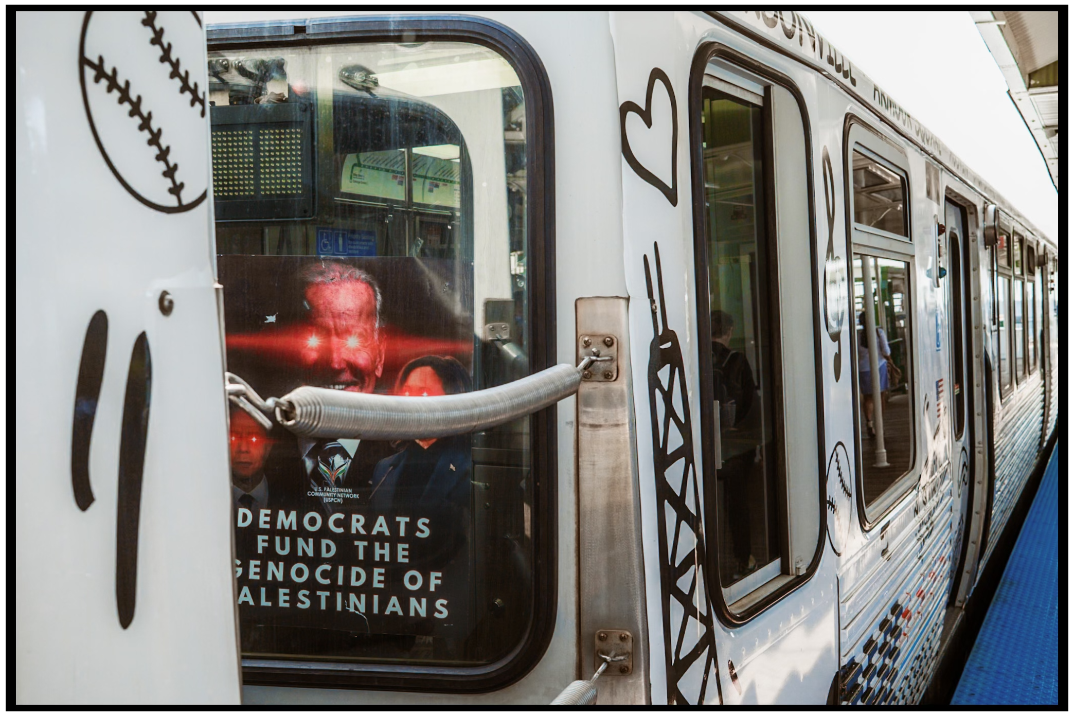 View through subway train windows showing protest signs and graffiti. Chicago. March on DNC