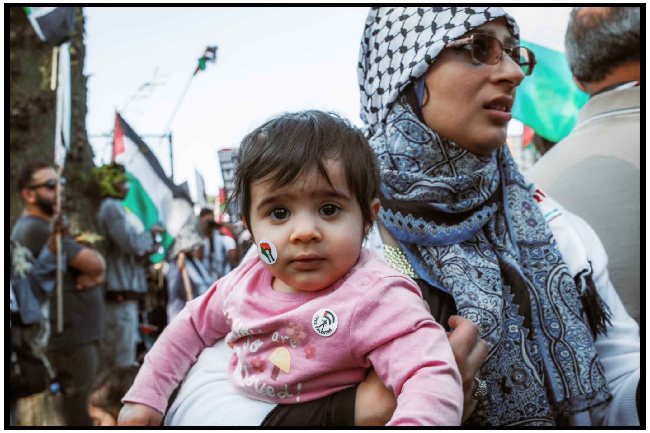 A peaceful protest gathering with Palestinian flags and traditional dress. Chicago. March on DNC