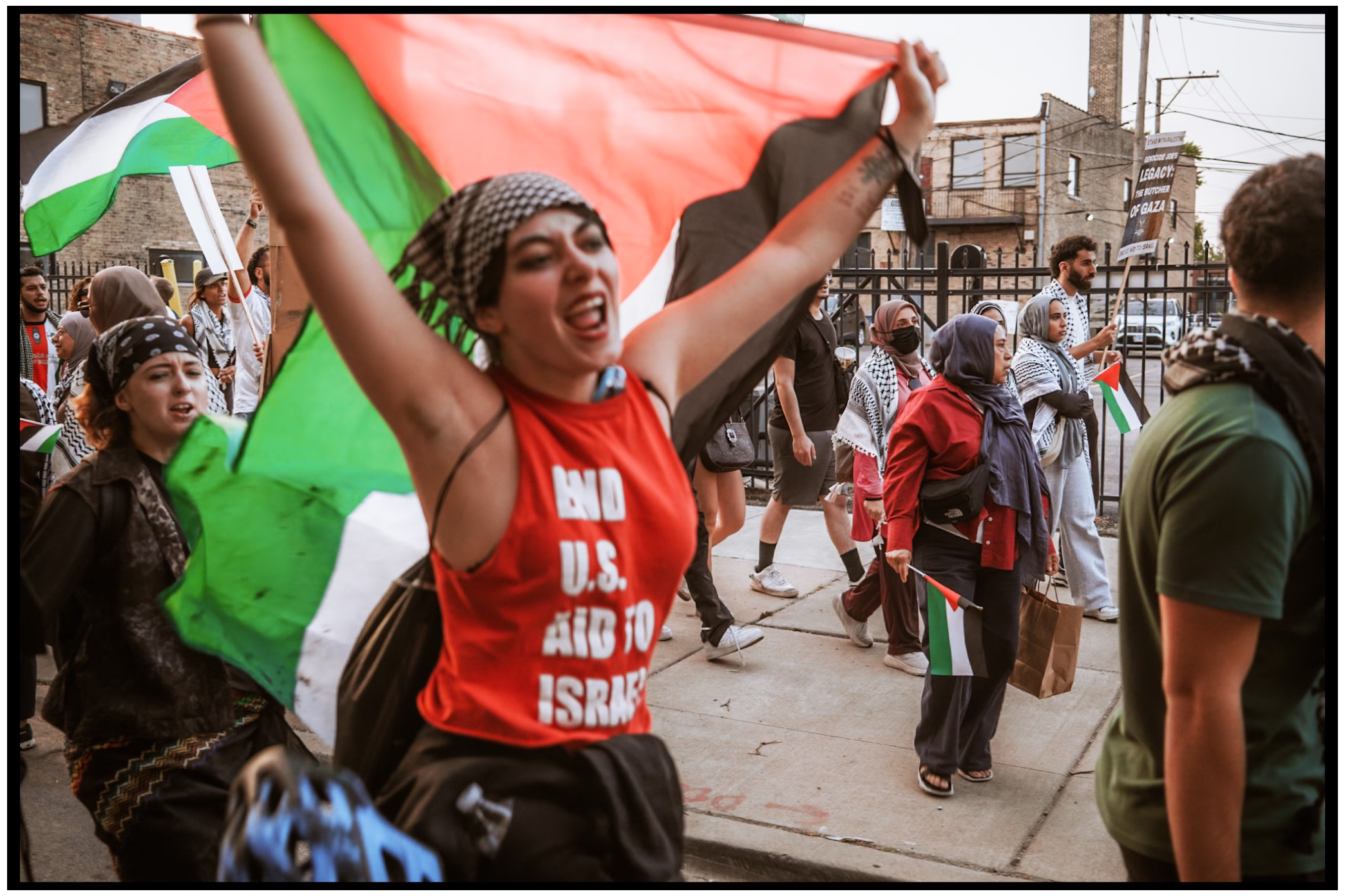 Protesters wave Palestinian flags during a street demonstration. Chicago. March on DNC