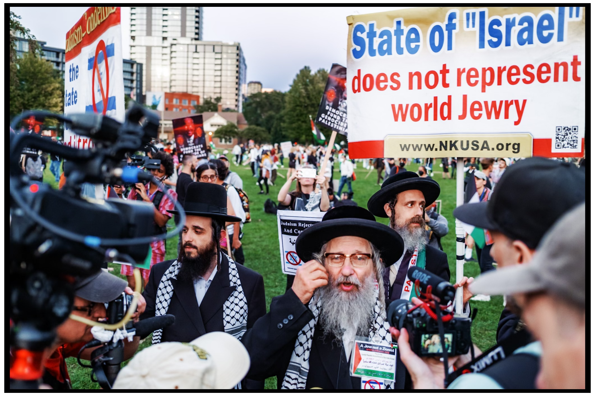 Orthodox Jewish protesters hold signs expressing views on Israel. Chicago. March on DNC