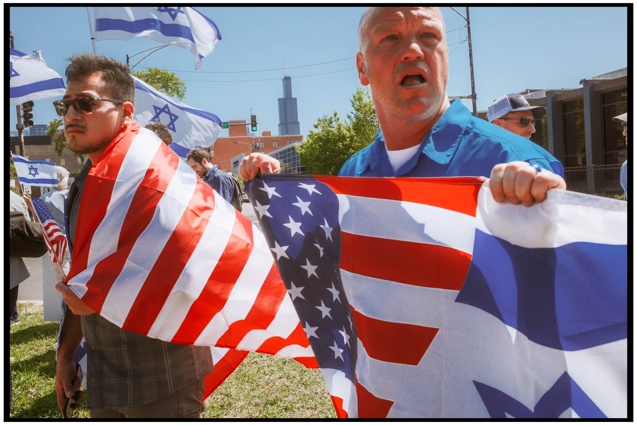 Demonstrators display American flags during outdoor protest. Chicago. March on DNC