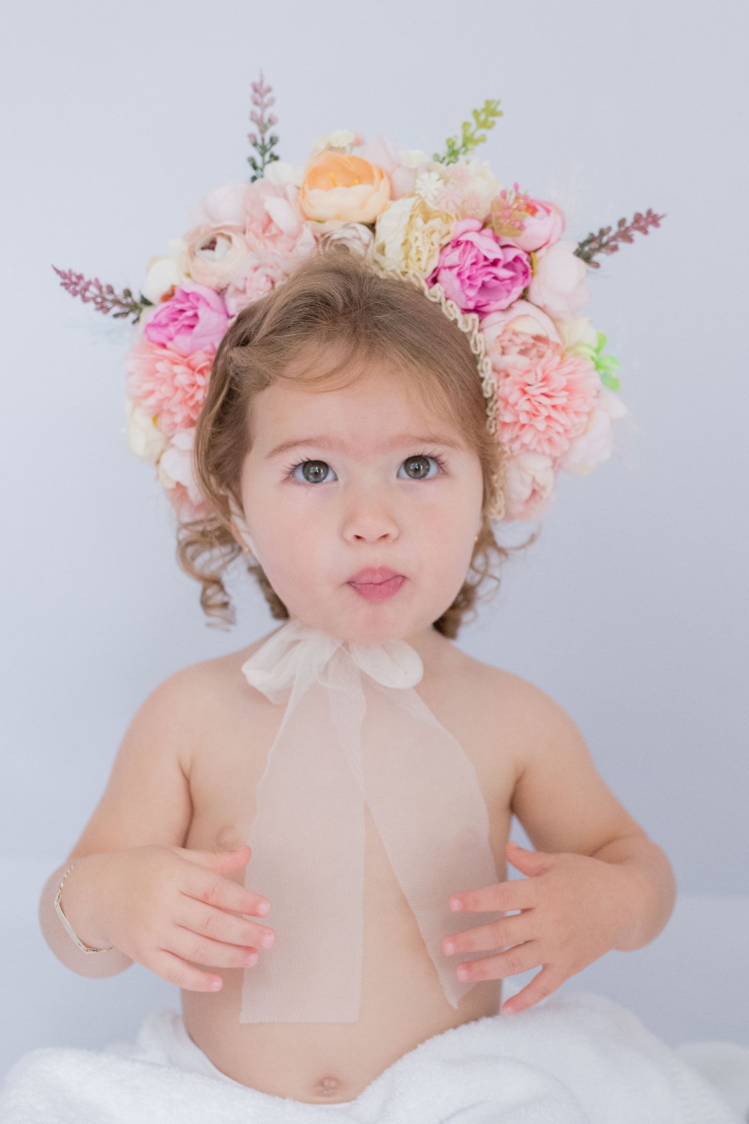 Beautiful girls wearing flower crowns, radiating sweetness and elegance, capturing a charming and memorable moment in a photo session!