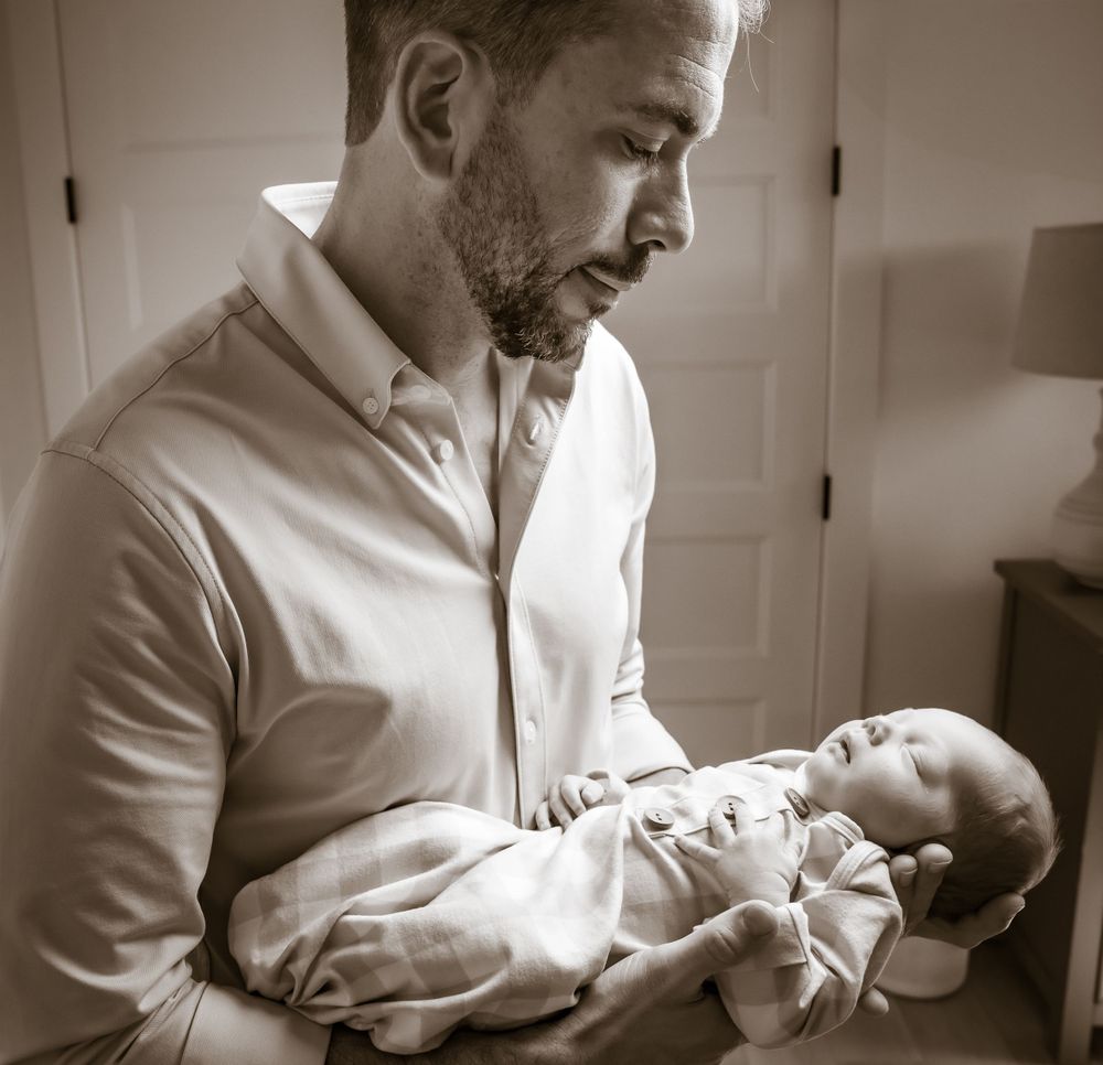 Black and white series showing gentle moments with a newborn.