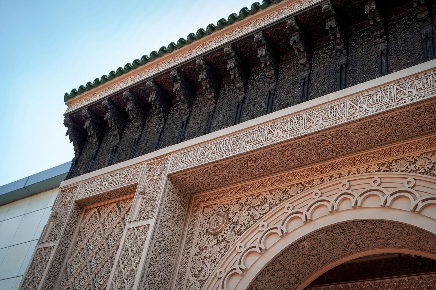 Intricate Moorish architectural details with carved arches and wooden cornices.