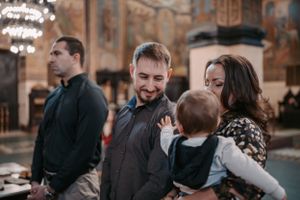 Candid moment of people sharing joyful expressions during a church ceremony.