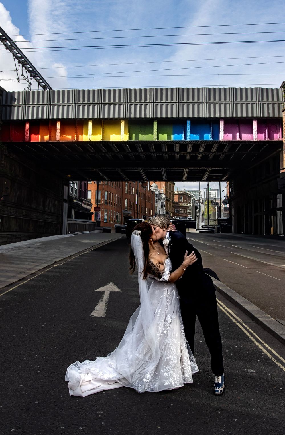 LGBTQ + Wedding in Leeds shot in the road with Rainbow over pass