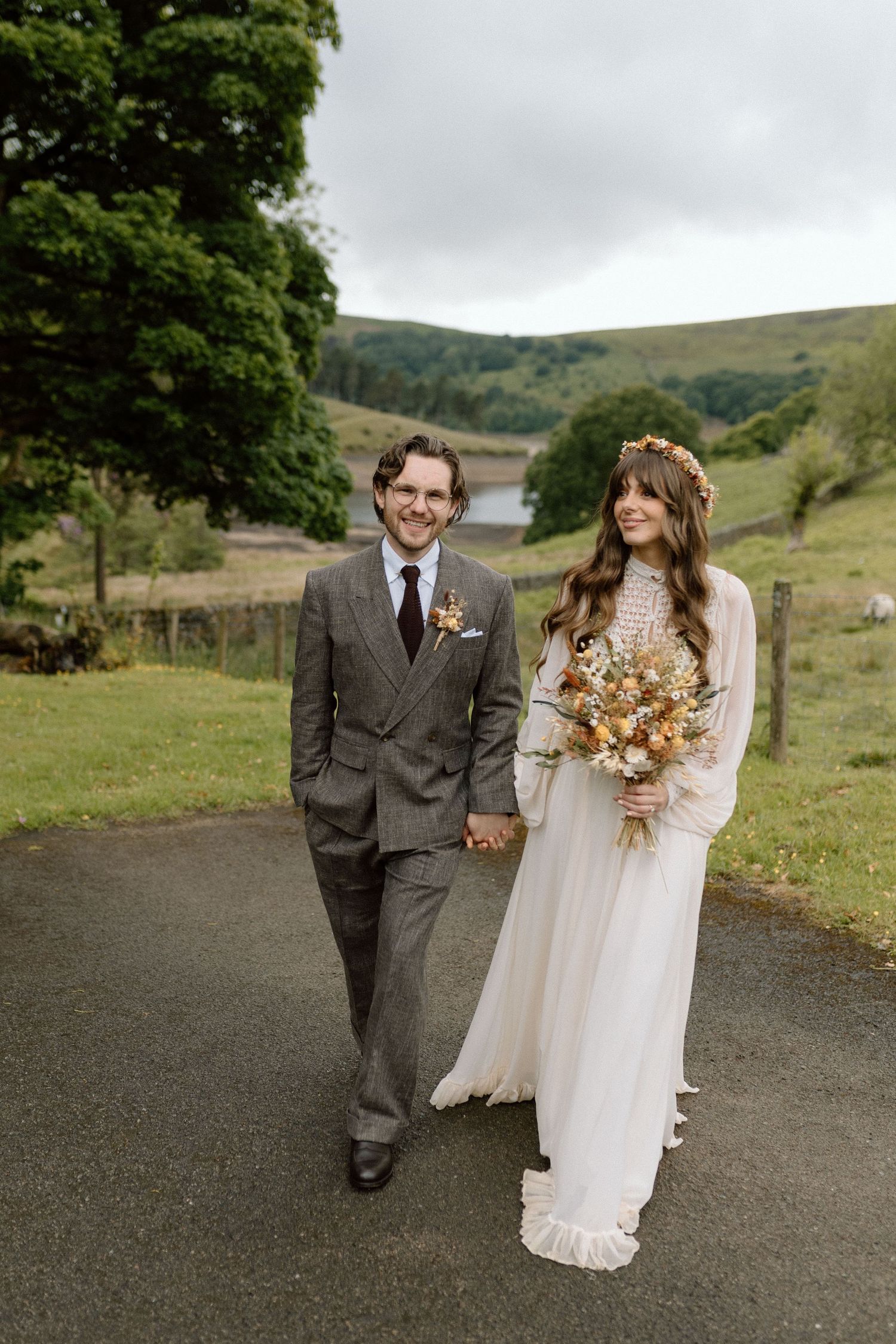 A bride and groom having wedding portraits taken at Upper House, Hayfield in Derbyshire.