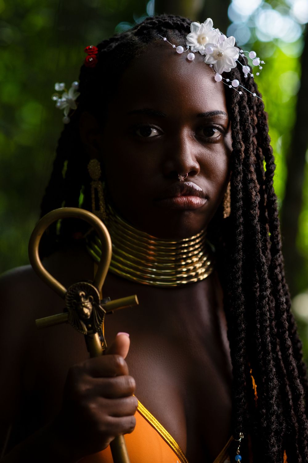 Portrait showing traditional African-inspired jewelry and ornate hair accessories.