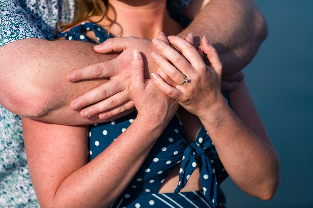 A person in a blue polka dot dress holds their hands close to their face in a sequence of similar poses.