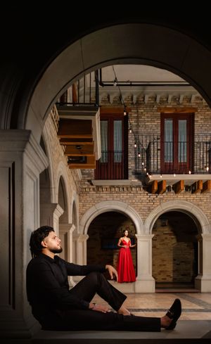 Dramatic sequence of silhouettes against stone archways and brick walls in a dimly lit historic building interior.