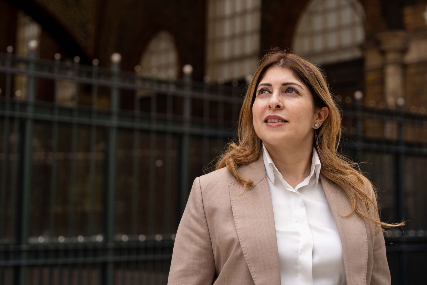 Professional woman outside Liverpool Street train station during her personal branding photoshoot in London