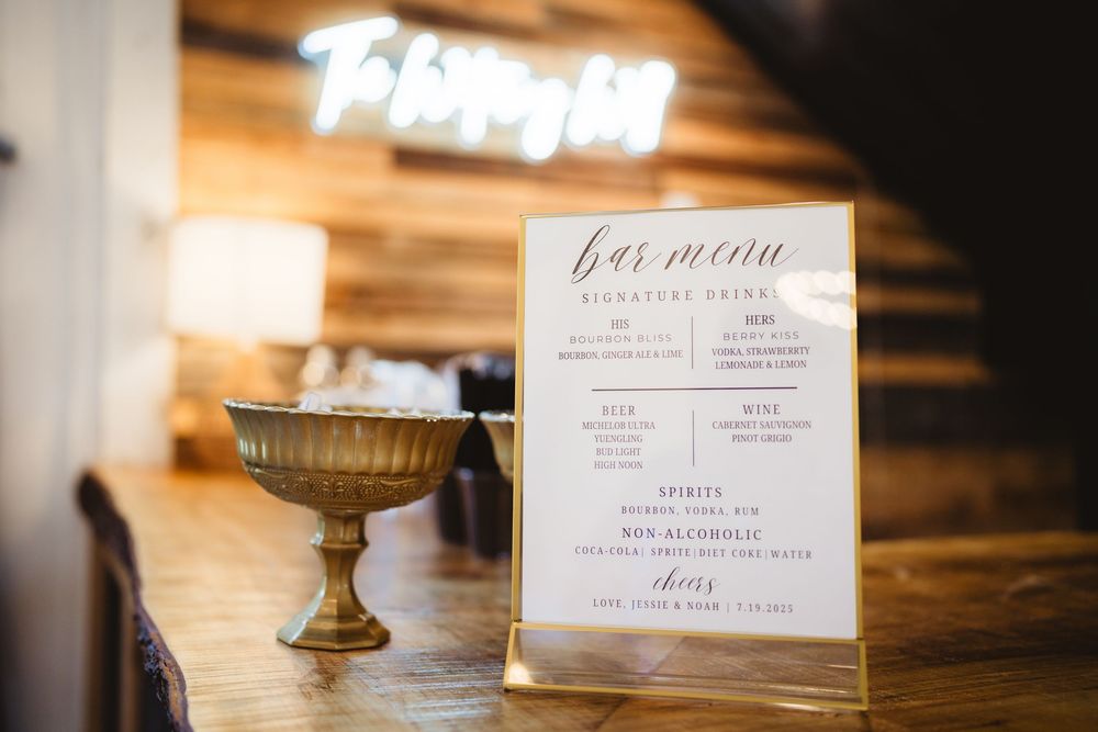 Elegant wedding reception table decorations with soft lighting and handwritten menu cards on display.