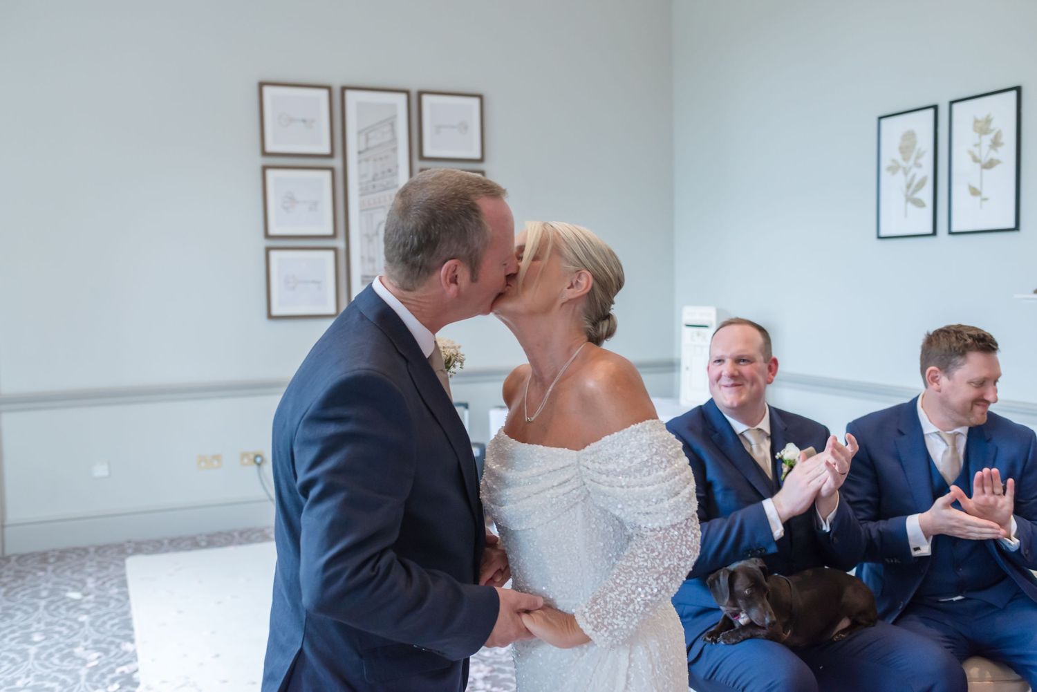 Bride and groom’s first kiss during a wedding ceremony at De Vere Cranage Estate; professional wedding photography by Michael Pardoe