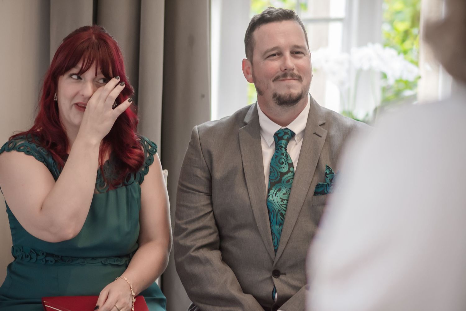 Candid emotional wedding guest moment during an intimate ceremony at De Vere Cranage Estate;  wedding photography by Michael Pardoe; Runcorn