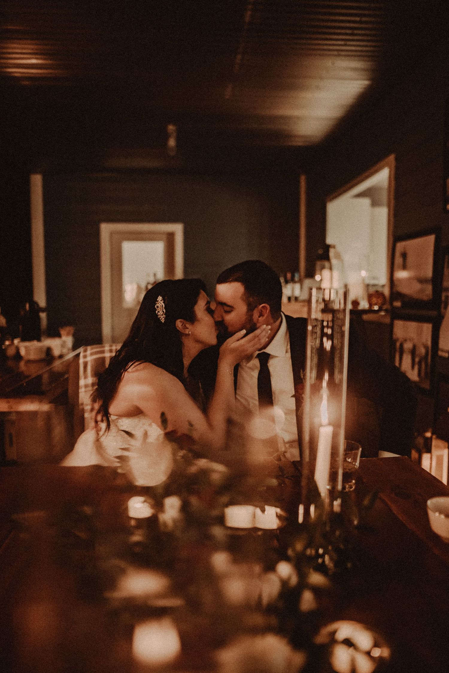 A romantic candlelit moment captured in warm sepia tones with glowing candles creating an intimate atmosphere.