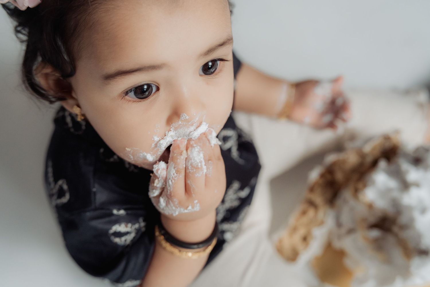 A playful sequence shows someone getting messy while eating chocolate cake with frosting smeared across their face.