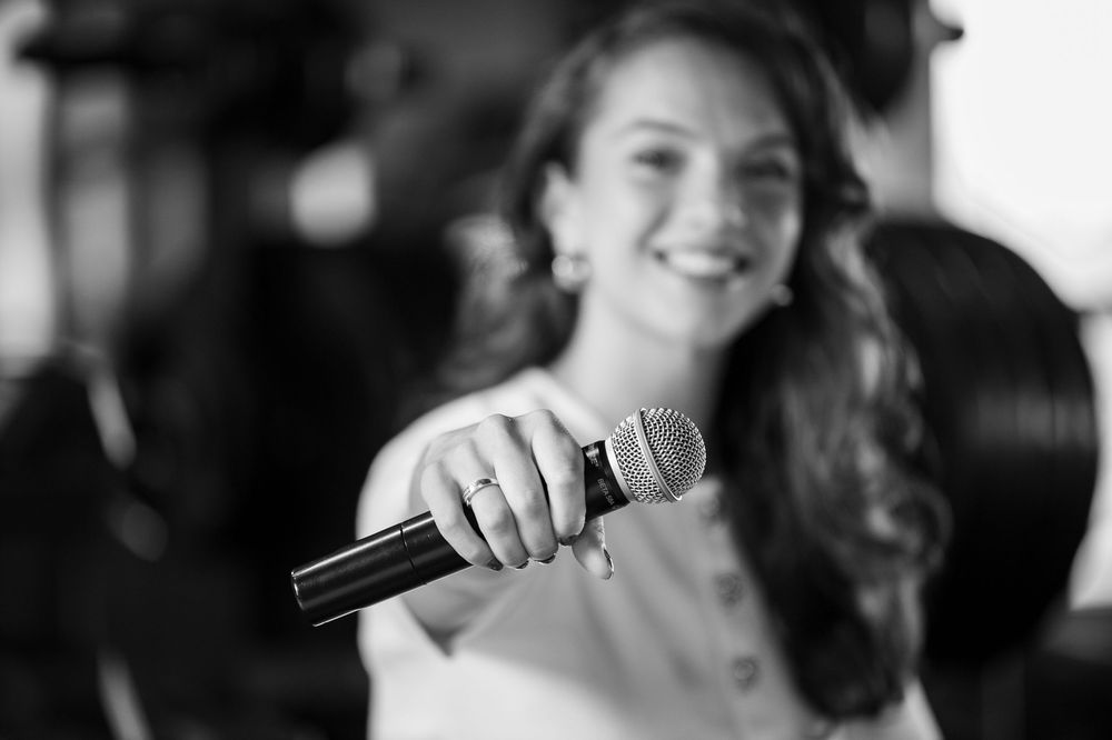 A black and white candid portrait showing joyful expression.