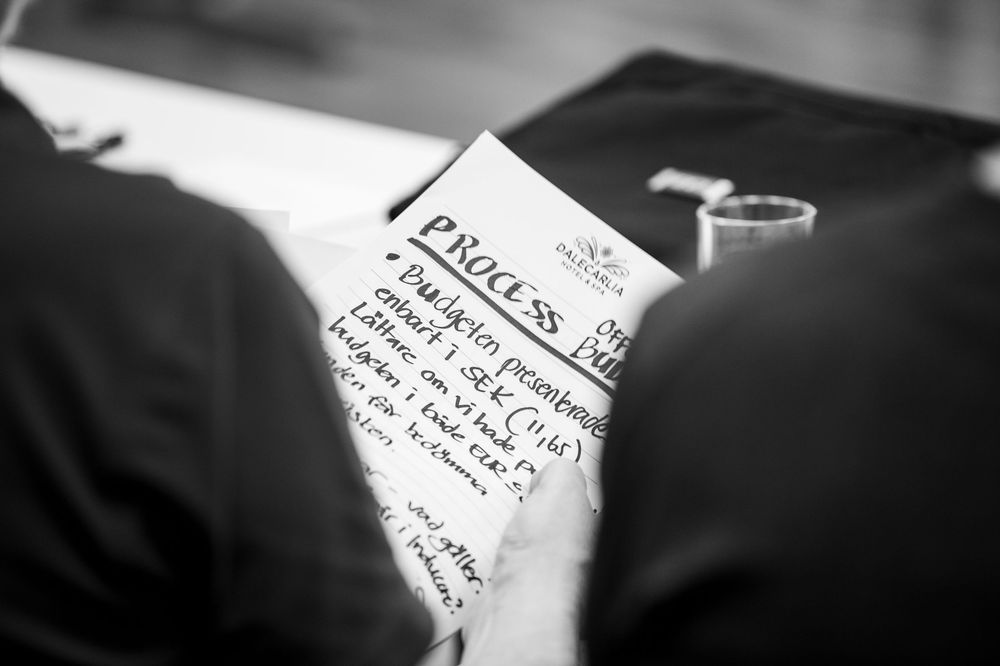 Handwritten notes and papers being reviewed during a meeting.