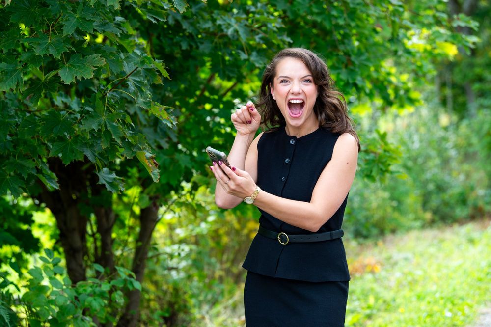 An energetic outdoor portrait session captured in a vibrant green natural setting.
