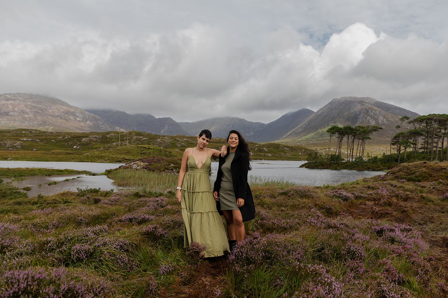 Couple surrounded by mountains in Connemara, Pine island in the background